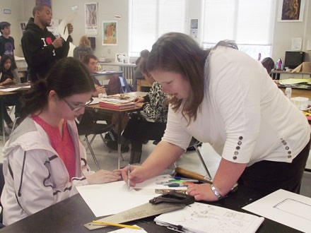 Art teacher Hope Steele works with fine arts students during class at Peachtree Ridge High.