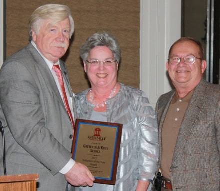 From left, Snellville Mayor Pro Tempore Tom Witts presents Gretchen and Kurt Schulz with the Snellville Tourism and Trade Marcy Pharris Volunteer of the Year award at a dinner at the Summit Chase Country Club in Snellville Saturday.