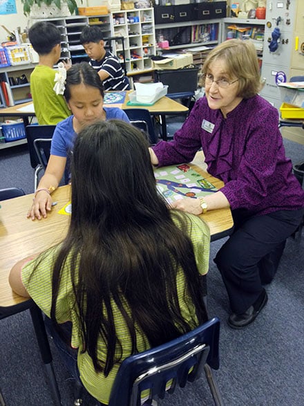 Veteran educator Marion Sebastian works with Riverside Elementary students.