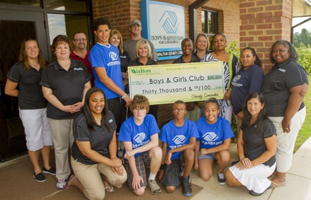 Walton EMC employees present a $30,000 check to the Boys and Girls Club of Walton County in Monroe from the proceeds of the Walton EMC Golf Classic. Pictured are (front row) Walton EMC employee Kimberly Willoughby, Boys and Girls Club members Connor Hall, Germain Dupervil, Anijah Guzamn and WEMC Charity Chair Kathy Ivie. Back row, left to right, WEMC employees Jennifer Lester, Kimberly Gilmore, Chris Stacey, Boys and Girls Club member Kyvin Thompson, WEMC employees Amanda Christian, Preston Roberts, Debra Jackson, Candace Patton, Tracey Guinn, Club Director Tina Epps, Club staff member Erica Cooper and WEMC employee Marilyn Briney. 