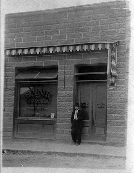 Tom Roberts before 1920’s in front of Bank of Grayson Bank on Main Street in Grayson GA. Photo Courtesy of the Geraldine Cooper Estate.