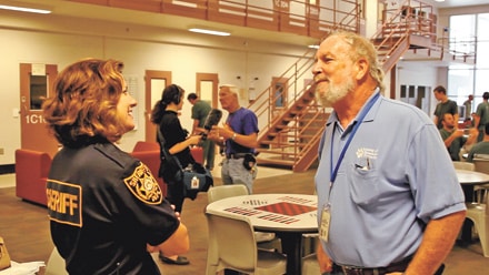  Deputy Stephanie Martinez-Peres with Dennis Kronenfeld inside the at the County Jail in Lawrenceville. 