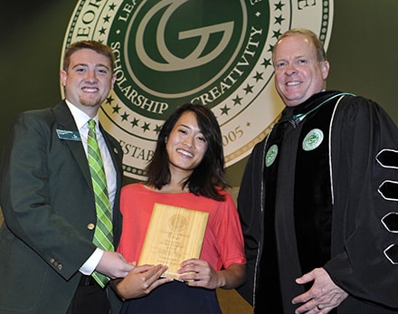 Gao Chia Vang, center, of Lawrenceville receives the Georgia Gwinnett College 2014 Outstanding Student Employee Award from Chase Goodwin, Student Government Association president and Dr. Stas Preczewski, GGC president. Vang was one of nine students among the faculty, students and staff recognized at GGC’s 2014 academic convocation ceremony.