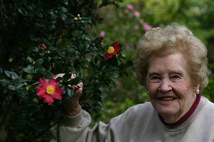 Margaret Moseley with Yuletide Camellia Sasanqua.