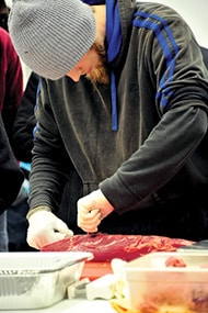 Representing Snellville’s Texas Roadhouse, Matt Knox, carefully trims a ribeye in the Texas Roadhouse Meat Cutting Competition at the University of Georgia Meat and Sciences Division.
