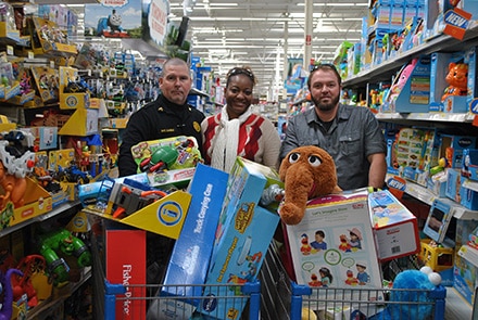 City of Duluth employees with a cartful of gifts going to 29 children through Blue Santa