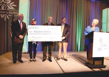 During Gwinnett Clean & Beautiful's 9th Environmental Address, Director Connie Wiggins (right) presented a $2500 scholarship to Rayann Arslan, a sophomore majoring in biology at Georgia Gwinnett College. Left to right: Gov. Nathan Deal, Rayann Arslan, GGC President Stas Preczewski, Tommy Hughes and Connie Wiggins.