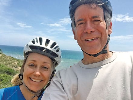 Becky and John Douglas taking a selfie while riding four-wheelers in the Dominican Republic.