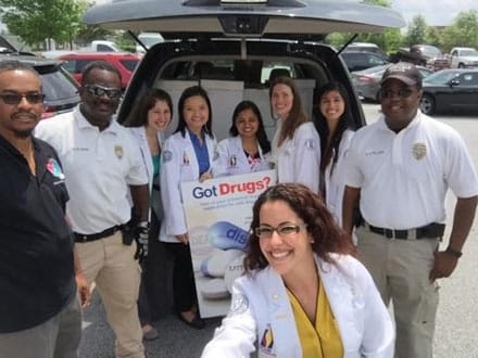 From left are DEA Diversion Investigator Ananias Green, Officer M.J. Sonny, Chelsea Davis, Trang Tu, Nidhi Gandhi, Catrina Hill, Erish Malonzo, Lt. Andre Sullivan. Kneeling is Hilda Alvarez. The women are second-year pharmacy students at The Philadelphia College of Osteopathic Medicine-Georgia Campus.