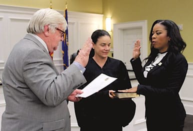 Tadia Whitner was sworn in as Snellville associate judge Monday. From left are Snellville Mayor Tom Witts, State Court Judge Carla E. Brown and Whitner.