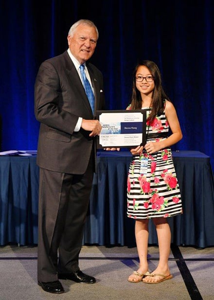 Coleman Middle School sixth grader, Sharona Huang stands proudly alongside Governor Nathan Deal as a second place winner in Georgia's Manufacturing Appreciation Week student design competition.