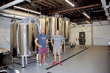 (L-R) John Reynolds and Dr. Marty Mazzawi with brewing equipment in place. They plan to start brewing early August and open in September. Meanwhile they will continue with facility renovations.