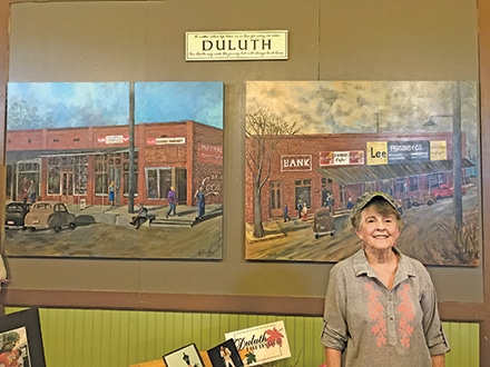 Completed in four months, Duluth artist, Ann Parsons Odum, points out that the mural on the left depicts Duluth in the 1930’s, while the painting on the right captures the spirit of the community in the late 1940’s. 