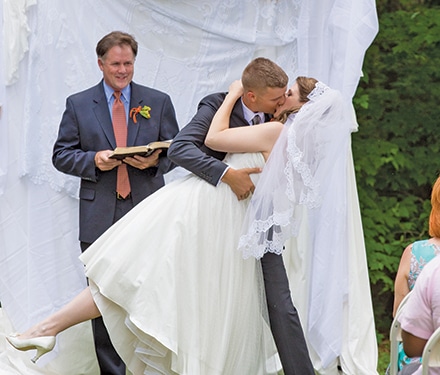 David King dips Kate Awtrey to kiss her after their wedding vows in May 2014.