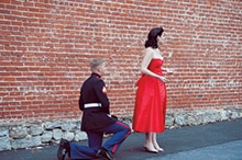 David King gets on one knee before Kate Awtrey right before proposing in Nov. 2013.