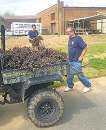 Beatty McCaleb and Richard Steele are busy moving plants