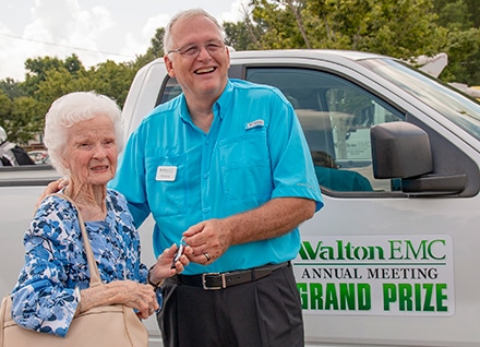 Beverly Johnson of Loganville won the grand prize recycled pickup. She receives the keys from CEO Ronnie Lee.