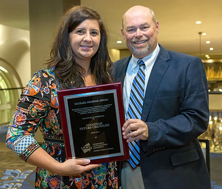 Walton EMC communicators Savannah Chandler and Greg Brooks celebrate her receiving the Cooperative Communicators Association's 2018 Michael Graznak Award. It is one of the nation's top honors for cooperative communicators. 
