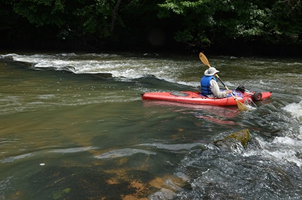 A kayaker shoots through a shoal on the Ocmulgee River during Paddle Georgia 2018.