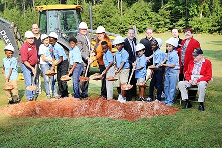 Students from Graves Elementary School, Gwinnett County commissioners and members of the Graves Family break ground on the Graves Park Phase II expansion.