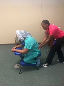 EVS associate Tracy D. Tarber receives a chair massage from massage therapist Lashita Hall.
