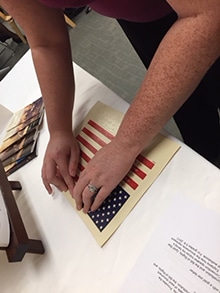 Reading the Pledge to the Flag of the United States of America in braille