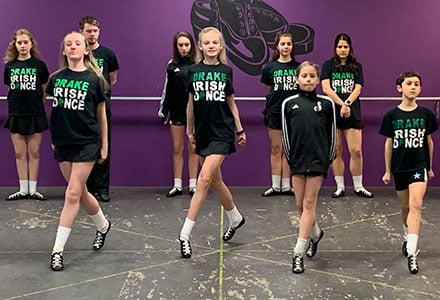 Students skip during a warmup routine at DRAKE School of Irish Dance in Berkeley Lake