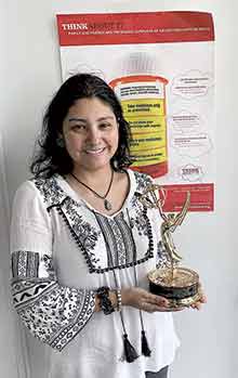 Diana Plazas, Director of the Gwinnett Chapter of GenRx, holds an EMMY award for the 30-minute documentary produced at CETPA, a nonprofit providing drug abuse and mental health counseling services in Norcross.