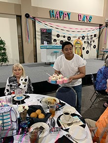 Buford Highschool’s Thespians and Theatre volunteered as servers for luncheon and held character as 1950s waiters as they escorted guests to their seats. The lunch was catered by Tropical Delights and assisted by Lanier College students and Career Academy. Cupcakes were made by Sharon Matson.