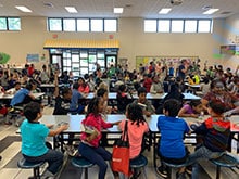 The entire third-grade class had gathered in Arcado Elementary’s bright cafeteria as Lilburn Woman’s Club volunteers handed them dictionaries to keep as their very own.