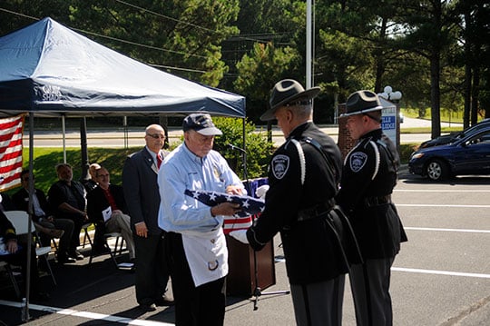 Dexter Harrison, a US Navy veteran and member of the Snellville Masonic Lodge hitched the banner to a pole during the Flag Day ceremony on June 14, 2019.