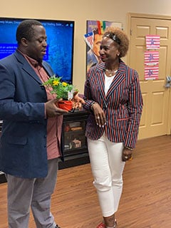 Executive Director Tato Gayflorsee presents Joyce Spraggs with a gift at McKinley Community Center’s rebranding ceremony. Joyce’s mother, Odessa Spraggs has been a participant at the center for two years, and they both enjoy the family-friendly atmosphere at McKinley.