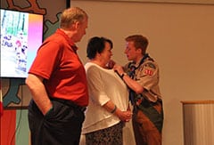 Allen Moore pins his parents, Beth and Paul Moore, to recognize their support throughout his Scouting journey.