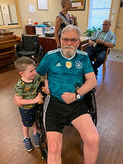  Longtime participant Frank Meyer and his grandson, Hollis Meyer at McKinley Community Care Center. Occasionally, Frank leads “Pictionary with Frank” with fellow participants at the Center.