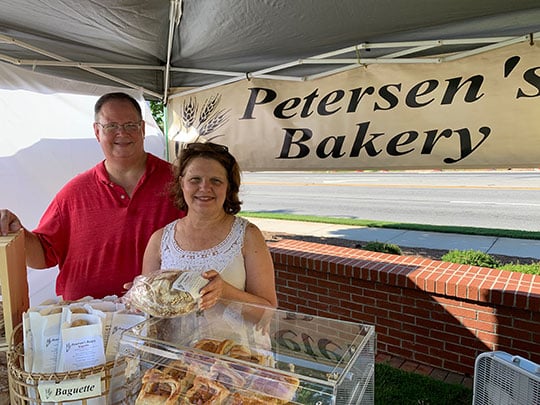 Every Saturday from June through September, Mark and Debbie Petersen can be seen at the Snellville Farmer’s Market, standing behind a booth laden with breads and pastries of all shapes and sizes.