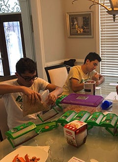 Marco and Juan working with mealworms for their upcoming Science Fair where they will test the effects of "e-juice", the liquid used in E-Cigarettes.