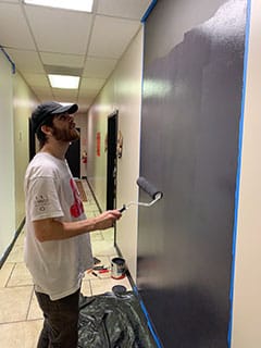 Nathan Peña working on a mural at the Hearts toNourish Hope center in Lawrenceville.