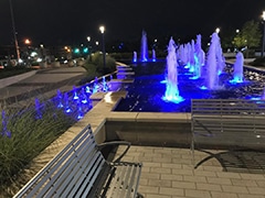 A fountain in Sandy Springs lit up purple to honor veterans bearing a Purple Heart Badge having been wounded in combat while serving in the US Armed Forces.