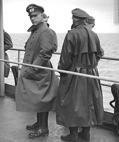 German officer in raincoat on board a ship to U.S. to Prisoners of War camp.