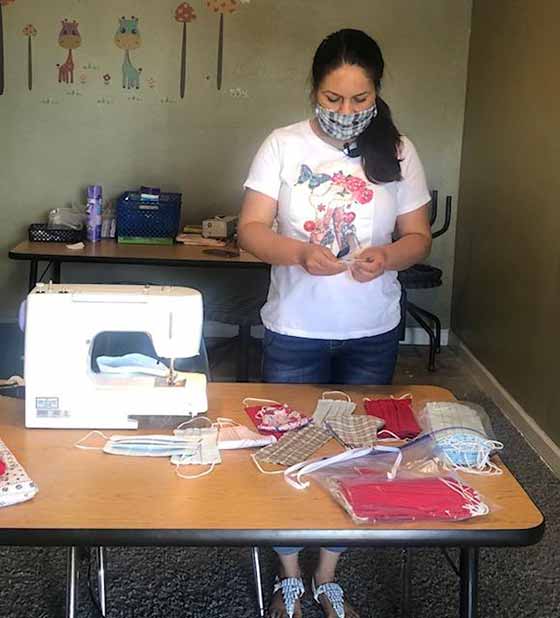 Corners Outreach Mom Azucena is sorting through the masks she has made.