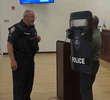 Special Police Officer (SPO) Mike Johnson, left, tells a student about the heavy police shield used by the county’s Special Response Team.