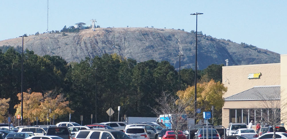 Stone Mountain, officially opened as a state park in 1965, towers over the Walmart Shopping Center in Mountain Park