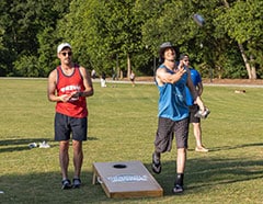 Two players take turns tossing the bags in recent Cornhole League action at Lilburn City Park. (Photo by Councilmember Emil Powella)