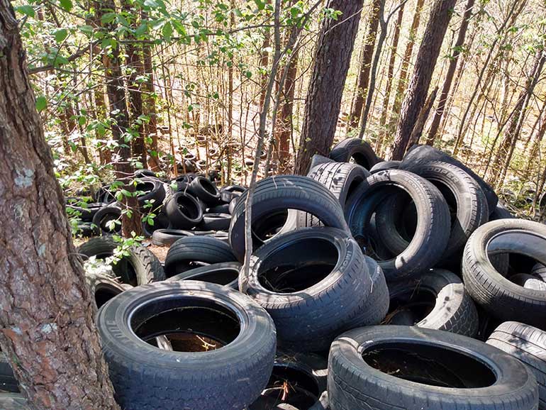 MASSIVE TIRE DUMP – The City of Lilburn made history during the spring by becoming the first local government in Gwinnett County to utilize the Georgia Environmental Protection Division (EPD) program helping property owners clean up and remove illegal tire dumps. Back in April, an estimated 3,000 passenger car tires were found illegally dumped on property behind the shopping center at 4805 Lawrenceville Highway. Police used surveillance and motion cameras in the apprehension of the suspects in the act of dumping. The City was able to help the property managers/owners by applying for funding under the EPD’s Scrap Tire Abatement Reimbursement (STAR) program. (Gwinnett Citizen Photo by Randy Louis Cox)