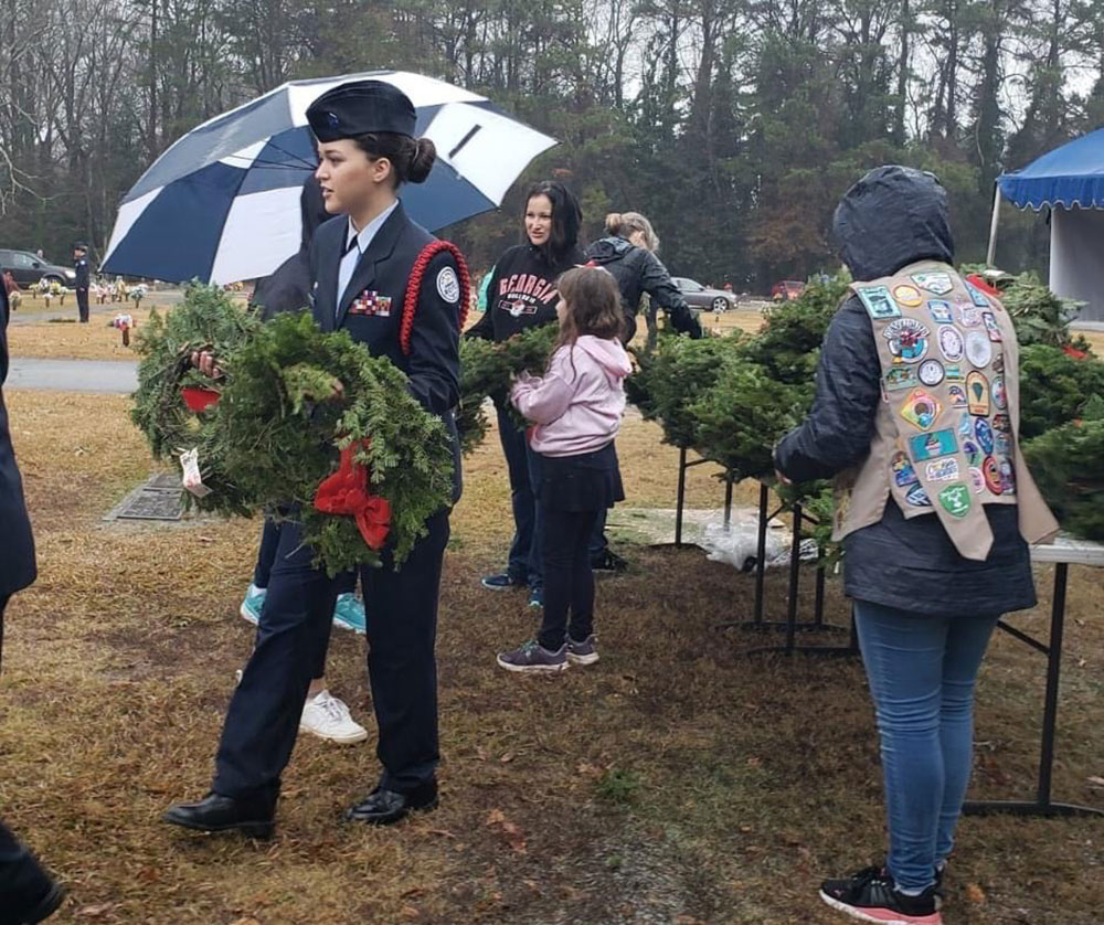 North Gwinnett H.S. Air Force JROTC Cadet, Marianna Phillips, prepares to lay wreaths on veterans’ graves, to show gratitude for their service and sacrifice. (Photo by Frank Marchese)
