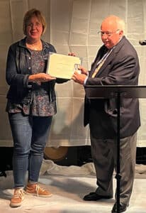 Laura Drake, Executive Director of Southeast Gwinnett Cooperative Ministry, receives the SAR Bronze Good Citizenship Medal and Certificate from Button Gwinnett Chapter President, Don McCarty. (Special Photo)