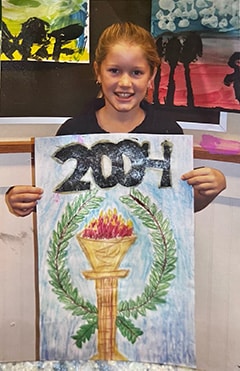 Katie, age 12, holding her artwork that was selected in a national competition to be displayed at 2004 Greece Olympics.